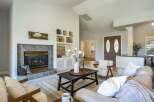 Step into this inviting living room, centered around a cozy fireplace with elegant tile surround and built-in shelving.