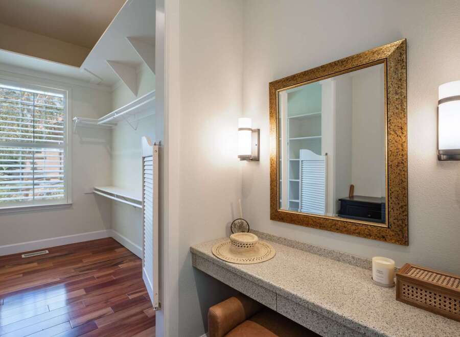 Discover a spacious walk-in closet with ample shelving and a large window, perfect for organizing your wardrobe.