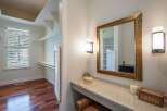 Discover a spacious walk-in closet with ample shelving and a large window, perfect for organizing your wardrobe.