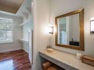 Discover a spacious walk-in closet with ample shelving and a large window, perfect for organizing your wardrobe.