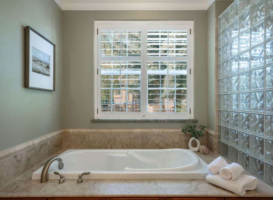 Indulge in relaxation in this luxurious bathroom featuring a spacious soaking tub, perfect for unwinding after a long day.