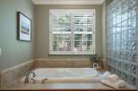 Indulge in relaxation in this luxurious bathroom featuring a spacious soaking tub, perfect for unwinding after a long day.