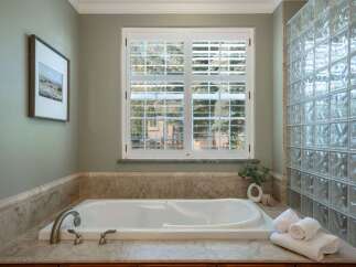 Indulge in relaxation in this luxurious bathroom featuring a spacious soaking tub, perfect for unwinding after a long day.
