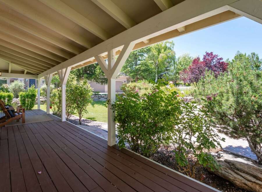 Enjoy the outdoors from this charming covered porch, perfect for relaxing with a cup of coffee.