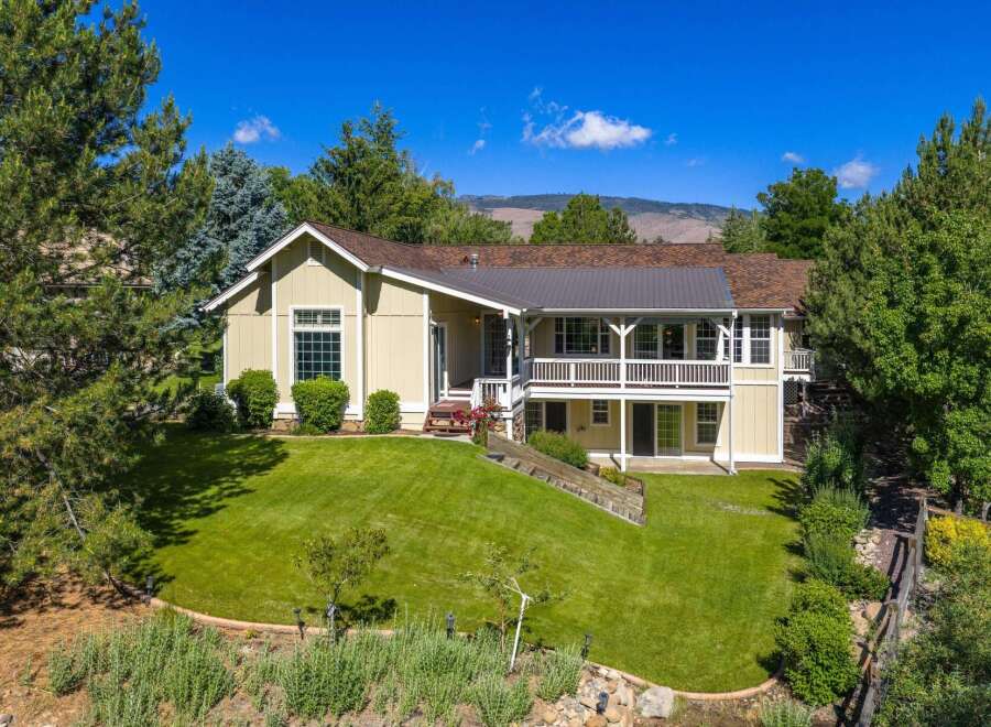 Discover this charming home nestled amidst mature trees and lush landscaping, offering a serene retreat.