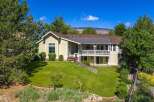 Discover this charming home nestled amidst mature trees and lush landscaping, offering a serene retreat.