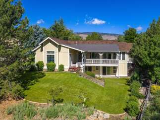 Discover this charming home nestled amidst mature trees and lush landscaping, offering a serene retreat.