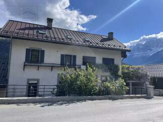 Charming property with a distinctive metal roof, offering a blend of classic design and modern appeal.