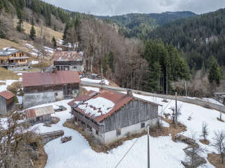 Nestled in a picturesque mountain setting, this property offers a unique blend of rustic charm and natural beauty.
