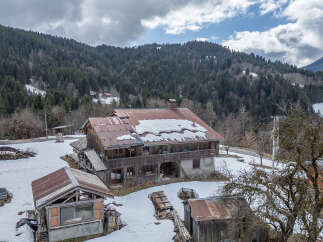 Nestled in a serene mountain landscape, this charming property offers a unique blend of rustic charm and natural beauty.