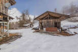 Discover a rustic retreat nestled in a serene, snow-covered landscape.