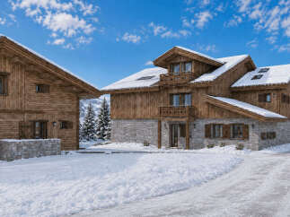 Experience the ultimate winter retreat in this stunning log cabin, nestled amidst snow-covered mountains and evergreen trees.