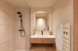 Step into a beautifully designed bathroom featuring modern fixtures and a warm, inviting aesthetic.