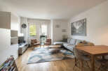 This stunning living space boasts a modern design with a comfortable sectional sofa and a stylish coffee table.