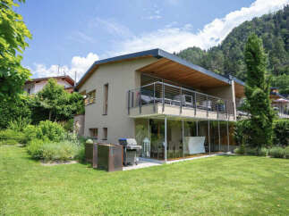 Discover modern living in this stunning property featuring a sleek design and expansive glass walls.