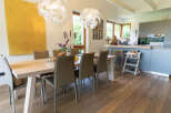 This stunning dining area features a modern design with a sleek wooden table and comfortable chairs.