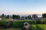 Enjoy stunning views from this beautiful property, featuring a charming playhouse and lush greenery.