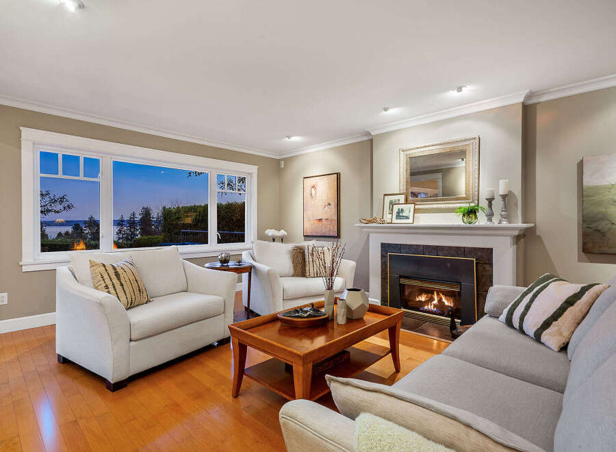 Experience luxury living in this stunning property, featuring a cozy living room with a fireplace and a breathtaking view.