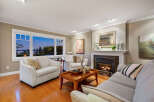 Experience luxury living in this stunning property, featuring a cozy living room with a fireplace and a breathtaking view.