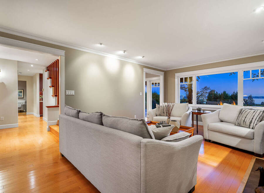 Step into luxury with this stunning living room, featuring a cozy sofa and two armchairs, perfect for relaxation.