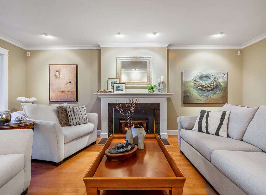 Step into luxury with this stunning living room, featuring a cozy fireplace and elegant decor.