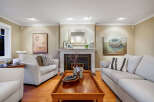 Step into luxury with this stunning living room, featuring a cozy fireplace and elegant decor.