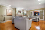 Step into luxury with this stunning living room, featuring a cozy fireplace and elegant hardwood floors.
