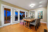 This stunning dining room boasts an elegant design with a beautiful wooden table and stylish chairs.