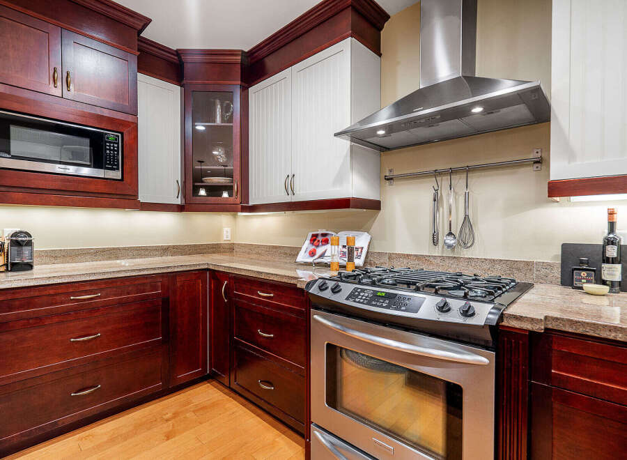 This stunning kitchen boasts rich, dark wood cabinetry that exudes warmth and sophistication.