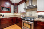 This stunning kitchen boasts rich, dark wood cabinetry that exudes warmth and sophistication.