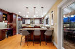 This stunning kitchen boasts rich, dark wood cabinetry and a spacious layout, perfect for both cooking and entertaining.