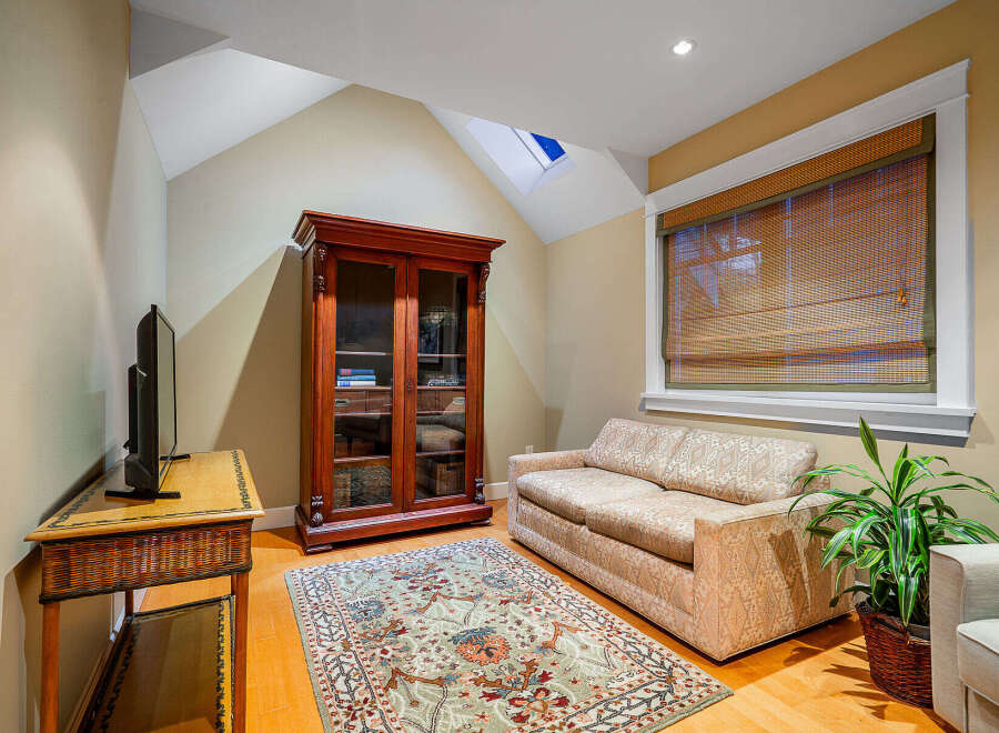 Step into this inviting living space, featuring a cozy sofa and a beautiful rug that adds warmth to the hardwood floors.