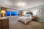 This stunning bedroom offers breathtaking views and a serene atmosphere.