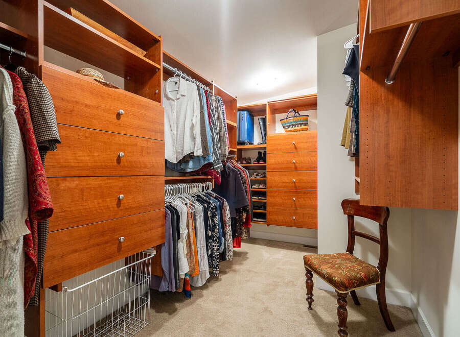 Step into luxury with this meticulously designed walk-in closet, offering ample storage and organization.