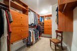 Step into luxury with this meticulously designed walk-in closet, offering ample storage and organization.