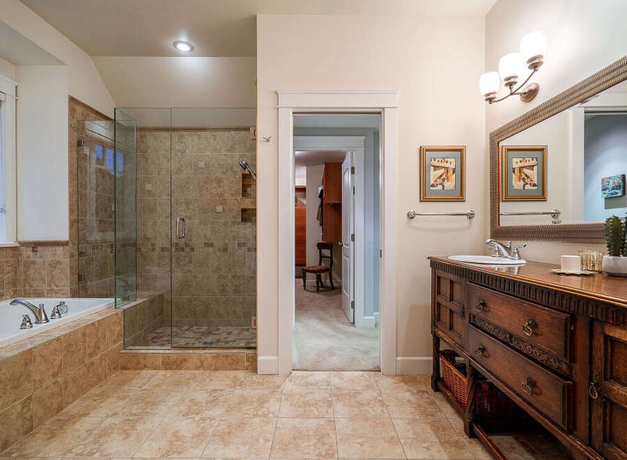 Step into luxury with this stunning bathroom! Featuring a spacious walk-in shower, a relaxing bathtub, and elegant tile work, this space is designed for ultimate comfort.