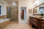 Step into luxury with this stunning bathroom! Featuring a spacious walk-in shower, a relaxing bathtub, and elegant tile work, this space is designed for ultimate comfort.
