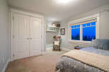 Step into this inviting bedroom, featuring a cozy rocking chair and a serene ambiance.