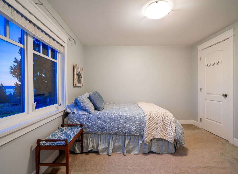 This charming bedroom offers a serene retreat with its cozy ambiance and inviting decor.