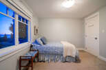 This charming bedroom offers a serene retreat with its cozy ambiance and inviting decor.