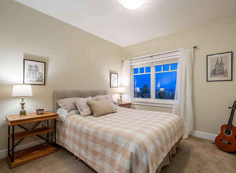 This cozy bedroom offers a serene retreat with its warm color palette and inviting ambiance.