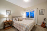 This cozy bedroom offers a serene retreat with its warm color palette and inviting ambiance.
