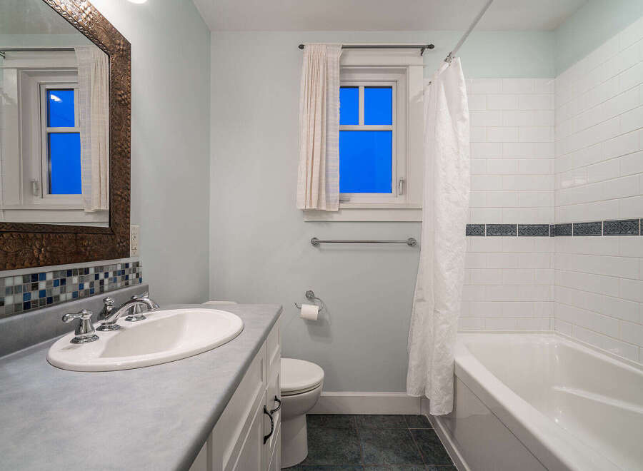 Step into this beautifully designed bathroom, featuring a sleek vanity and a pristine sink.