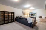 This inviting living space features a sleek black leather sofa, perfect for relaxing and entertaining.