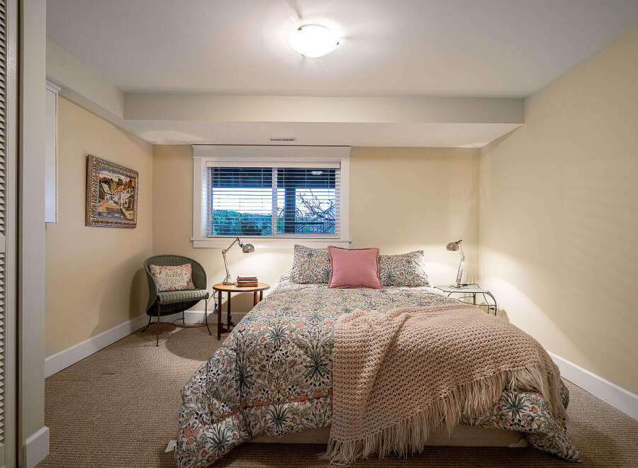 This cozy bedroom offers a serene retreat with its inviting ambiance.