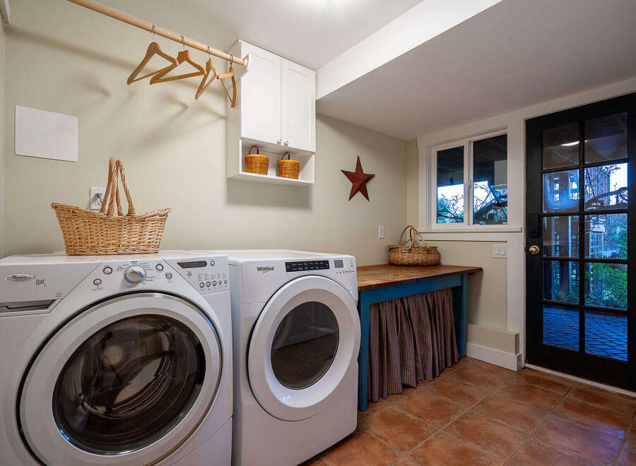 This charming laundry room features a modern washer and dryer set, perfect for efficient home management.