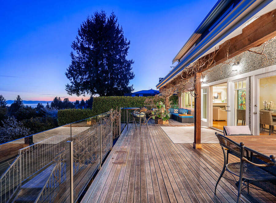 Experience luxury living with this stunning property featuring a spacious wooden deck, perfect for entertaining or relaxing.