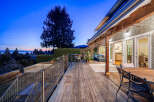 Experience luxury living with this stunning property featuring a spacious wooden deck, perfect for entertaining or relaxing.