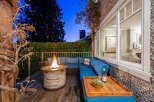 Experience luxury living in this stunning property featuring a cozy outdoor seating area with a fire pit, perfect for evening gatherings.
