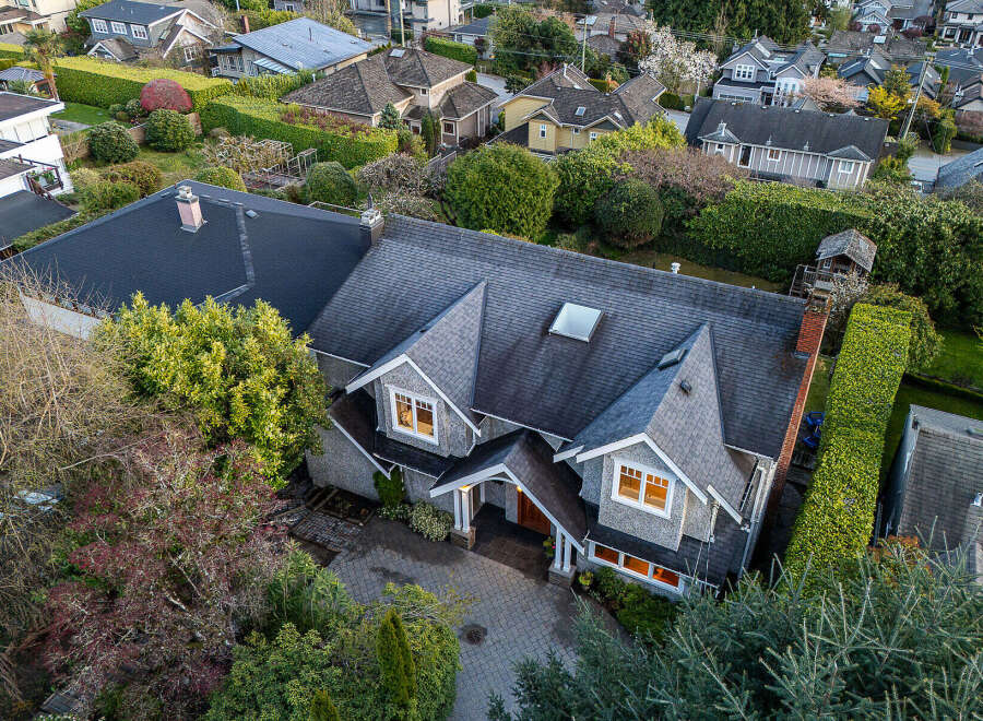 This stunning property boasts a beautifully designed exterior with a charming stone facade and a well-manicured landscape.